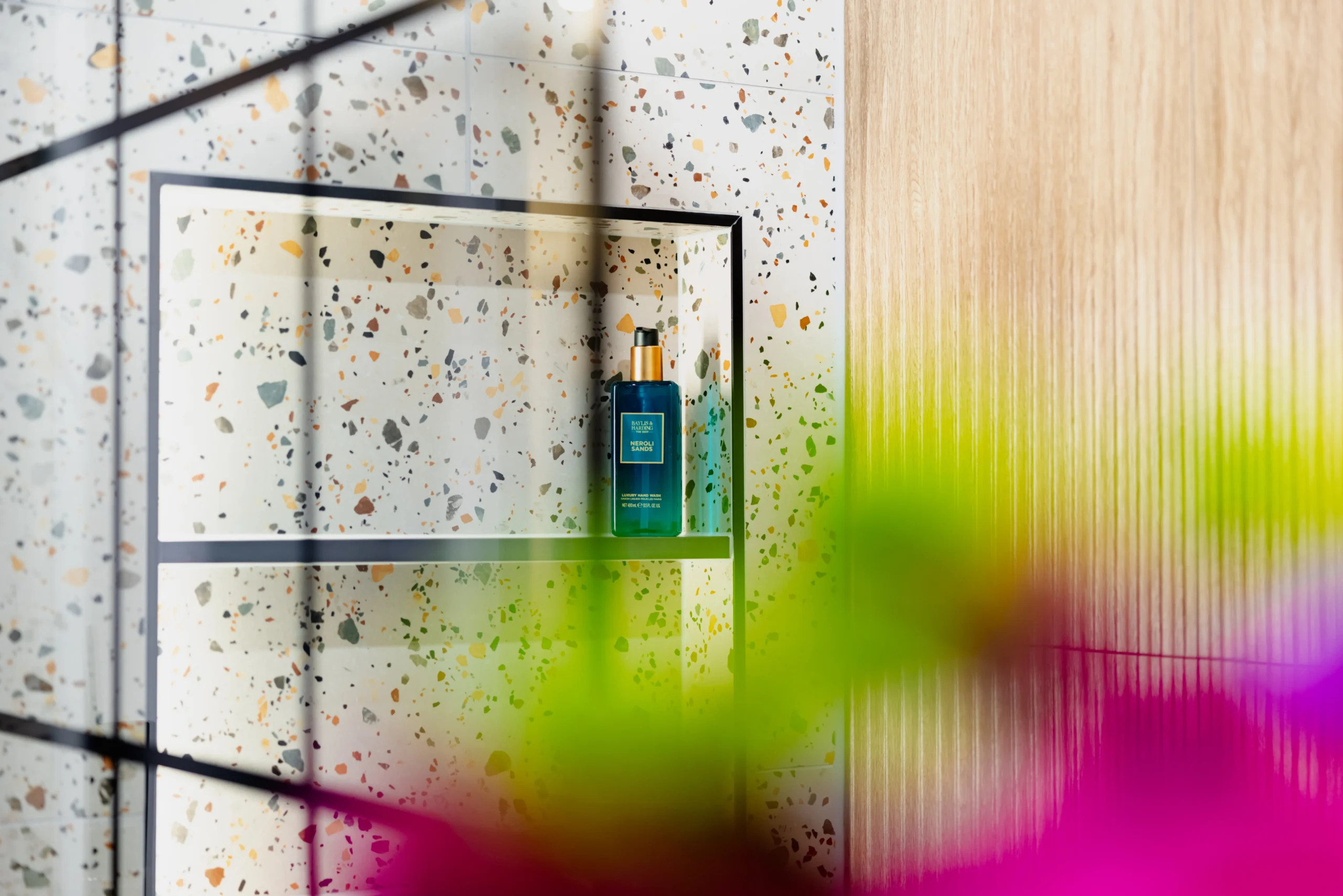 Walk-in shower room on display in the Newlook Tiles and Bathrooms Dublin showroom, with tiled walls and a glass screen