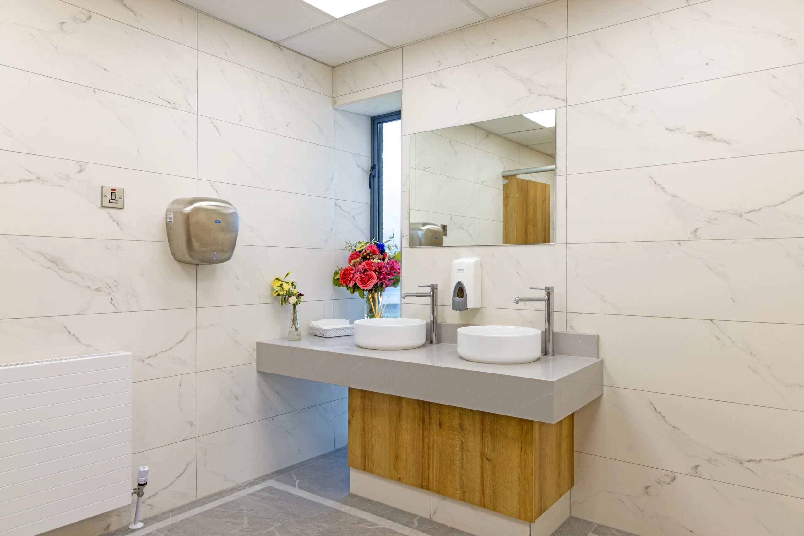 Bathroom vanity and marble effect wall tiles in a completed Newlook Tiles bathroom project