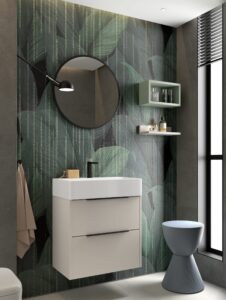 Matte mink 600mm wall hung vanity with round black mirror against bold tropical leaf wallpaper