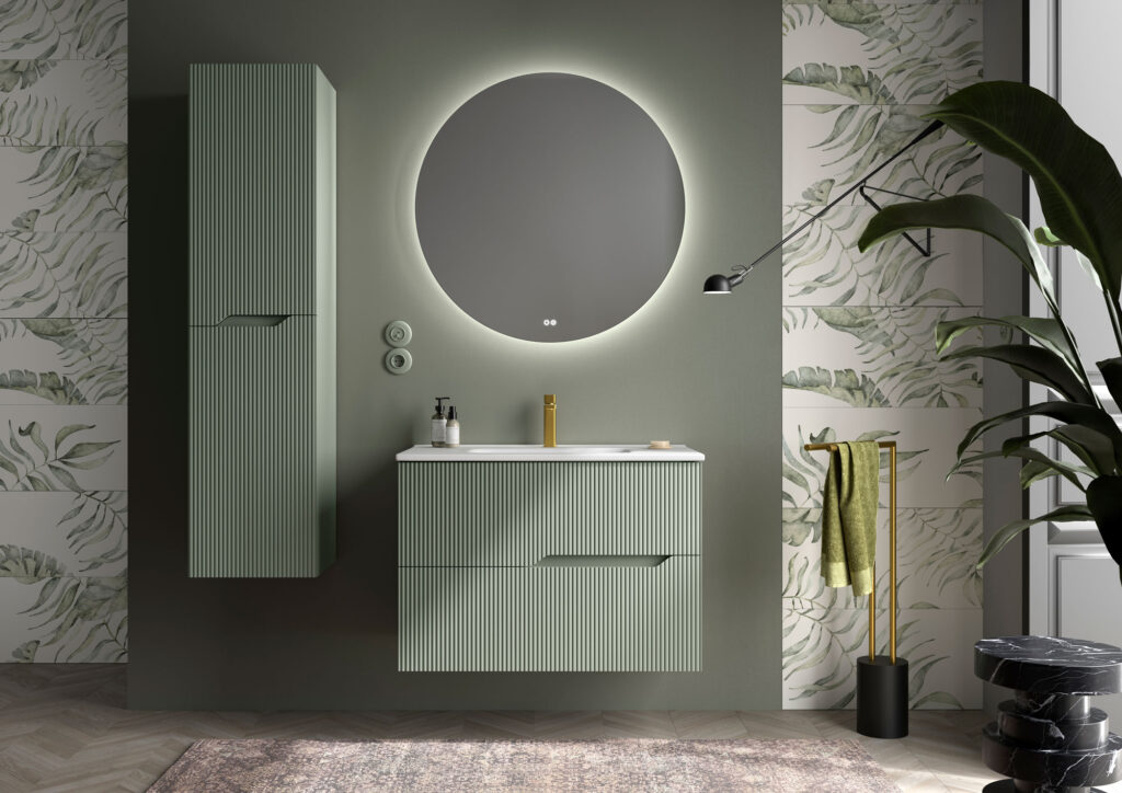 Sage green ribbed wall hung vanity with white basin and round backlit mirror on a green feature wall