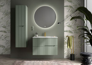 Sage green ribbed wall hung vanity with white basin and round backlit mirror on a green feature wall