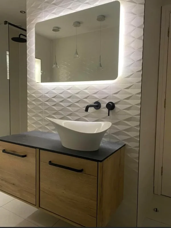 White 3D textured wall tiles behind a vessel basin on a oak floating vanity