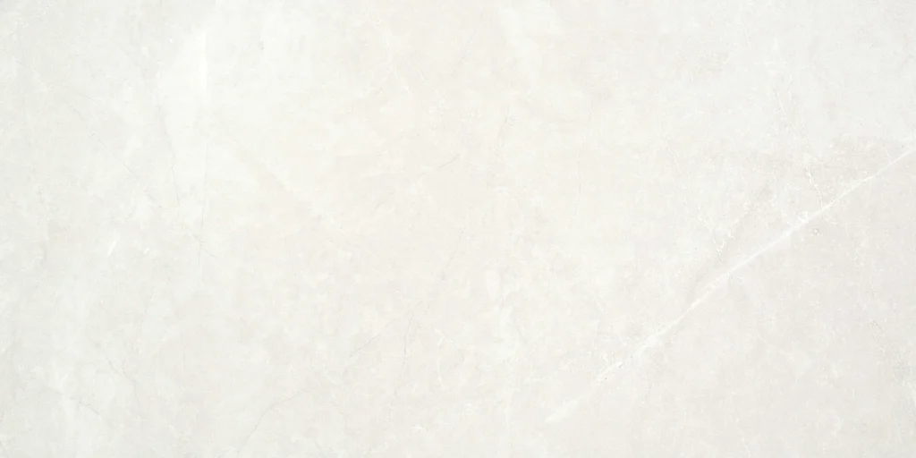 White marble-effect ceramic tile with soft grey veining across the surface