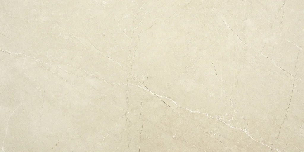 Cream ceramic decor tile with diagonal white veining on a smooth pale surface