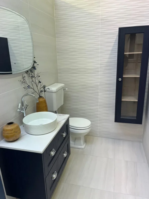 Wavy white décor wall tiles alongside beige tiles in a fitted bathroom