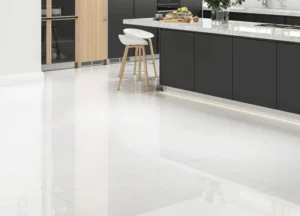 Glossy white floor tiles in a modern kitchen with dark cabinetry