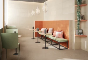 Terracotta ribbed wall tiles used as café banquette backdrop with sage green seating