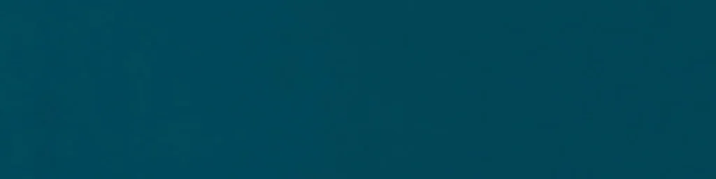 Close-up of a deep teal ceramic wall tile with matte finish