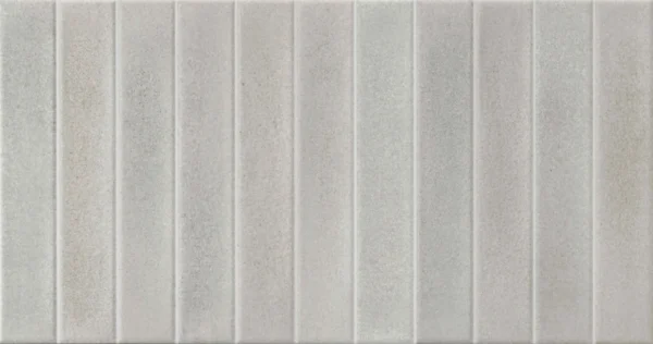 Light grey-beige ceramic wall tile featuring vertical ribbed linear texture