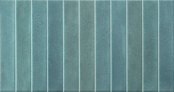 Teal green ceramic wall tile with raised vertical ribbed texture