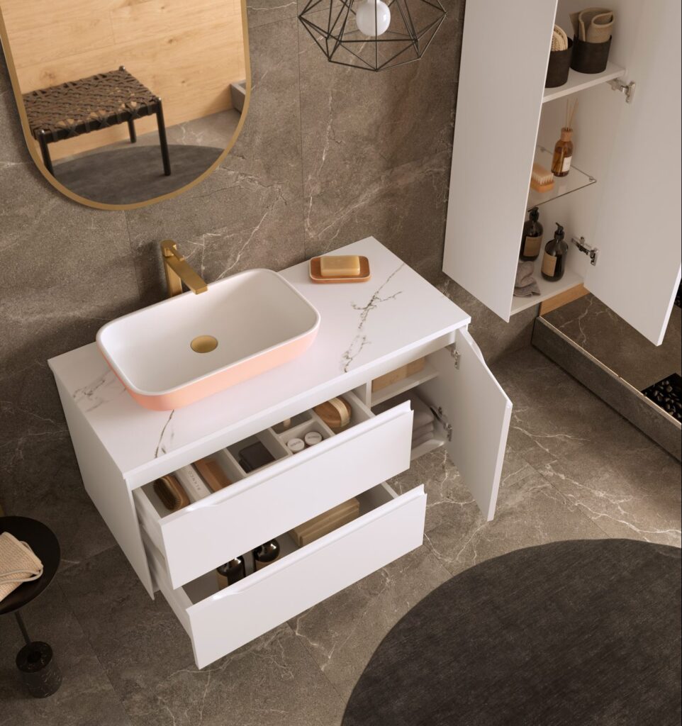 White vanity unit with open drawers, pink vessel basin and marble worktop