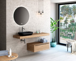 Matte black countertop basin on floating oak shelf with round backlit mirror and textured stone wall