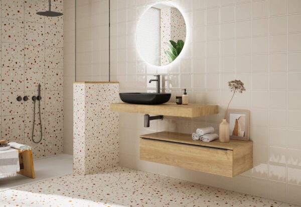 Terrazzo-tiled bathroom with black vessel basin on oak floating vanity unit
