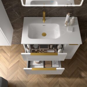 Overhead view of open white vanity drawers with gold handles revealing neatly organised bathroom essentials
