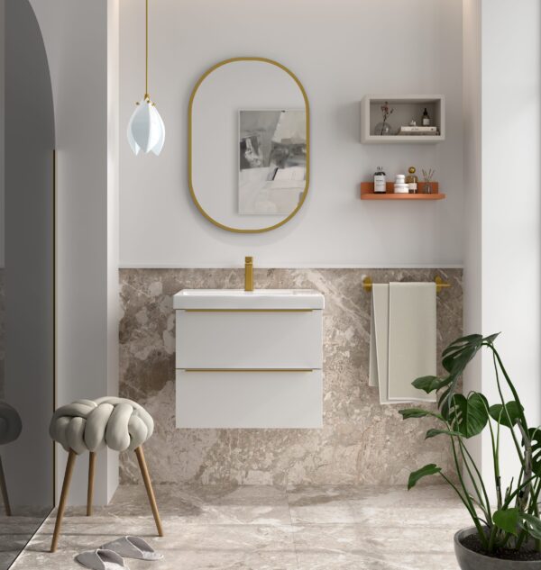 White wall hung vanity unit with gold handles and integrated basin beside marble-tiled splashback