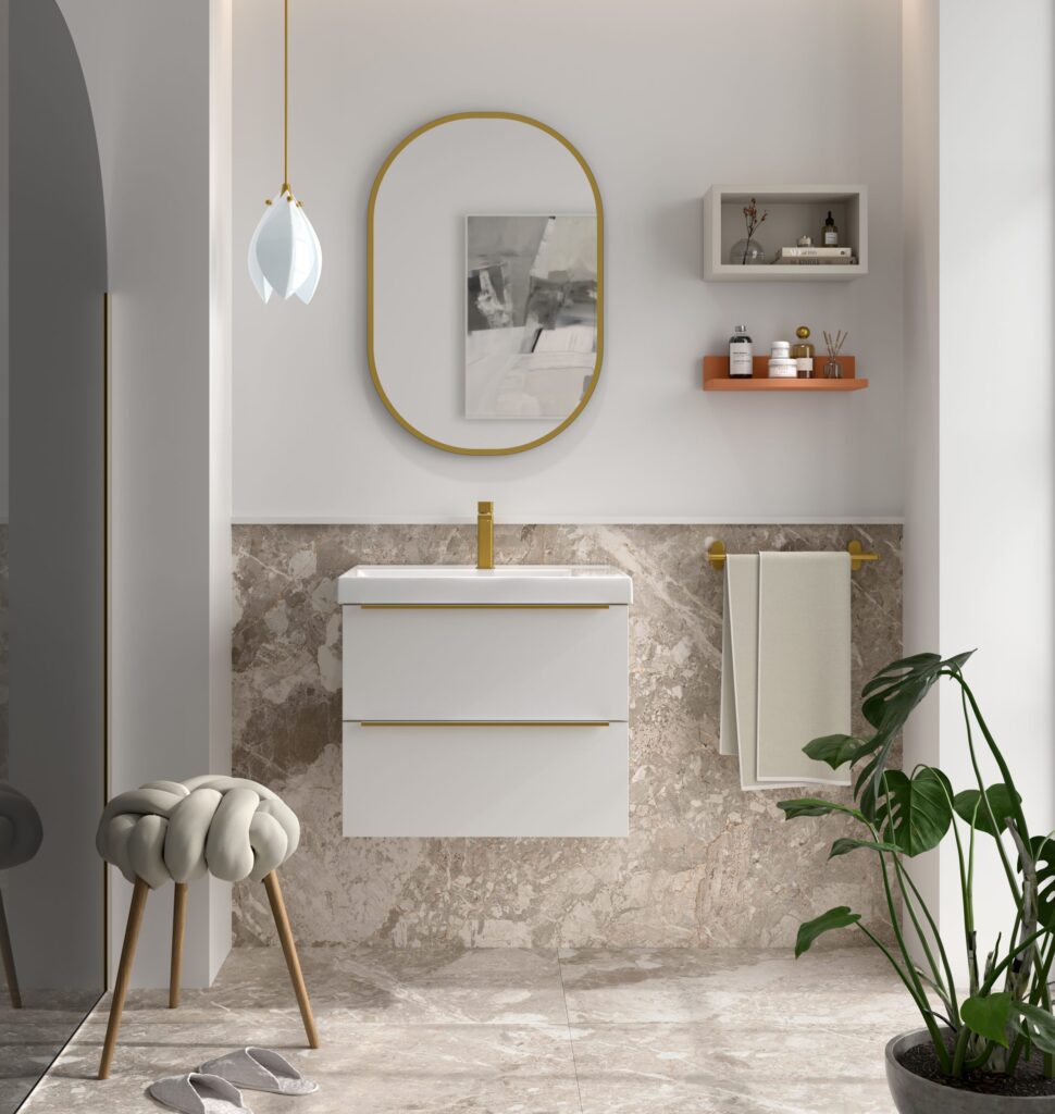 White wall hung vanity unit with gold handles and integrated basin beside marble-tiled splashback