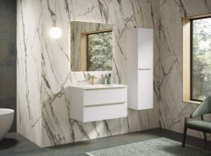 Gloss white vanity unit with gold handles against dramatic marble-effect tiled wall