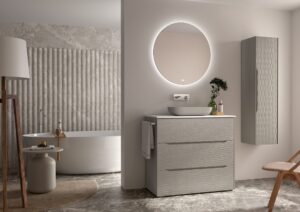 Greige ribbed 1000mm vanity unit with round backlit mirror and tall wall cabinet beside a freestanding bath