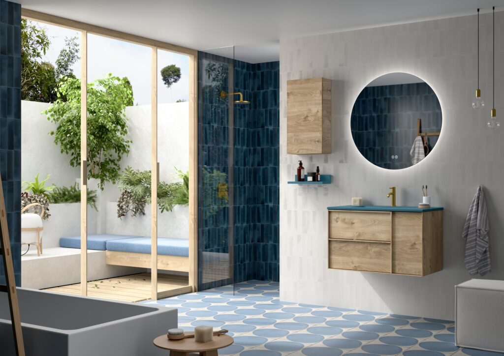 Oak wall hung vanity unit with teal basin top beside blue zellige tiled shower and round LED mirror