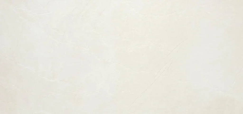Wide-format white marble-effect porcelain tile with faint diagonal veining