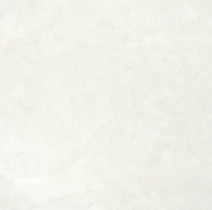 Close-up of a square white marble-effect porcelain tile with soft grey clouding