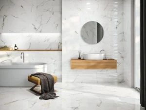 Elegant bathroom with polished marble-look wall tiles, round mirror and oak floating vanity
