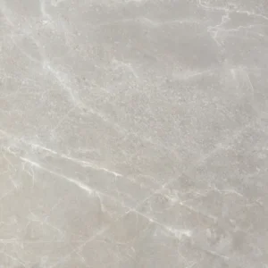 Close-up of a warm grey satin porcelain tile with sweeping white marble veining
