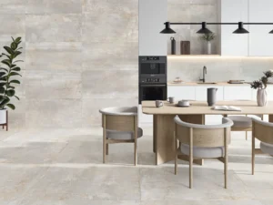 Pale grey stone-effect porcelain tiles on kitchen floor and full-height feature wall