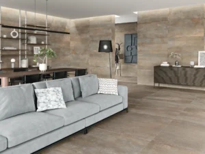 Warm brass-toned stone-effect tiles covering walls and floor of a contemporary living space
