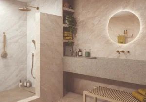 Modern bathroom with white quartz-effect wall tiles, brass fittings and round backlit mirror