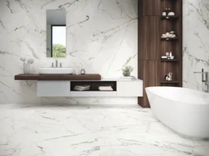 Spacious bathroom featuring white marble-effect tiles, freestanding bath and dark wood shelving unit