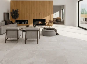 Bright open-plan living room floored with light grey stone-effect matt tiles
