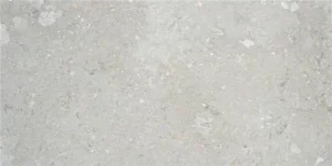 Pale grey stone-effect porcelain tile with white chip inclusions and matt finish