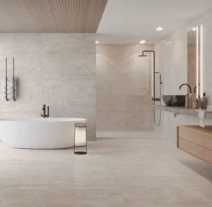 Luxury bathroom with freestanding bath and polished cream stone-effect tiles on walls and floor