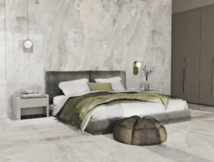 Luxury bedroom featuring polished pearl-toned onyx effect tiles on walls and floor
