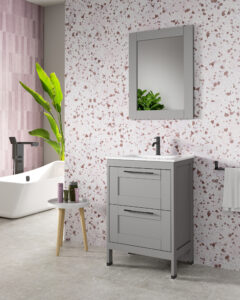 Grey 600mm vanity unit with black handles against pink terrazzo-effect wall