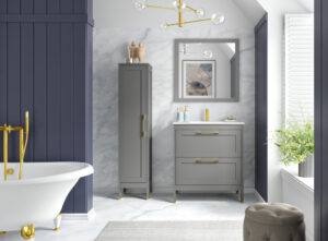 Grey vanity unit with gold handles beside a clawfoot bath and marble tiles