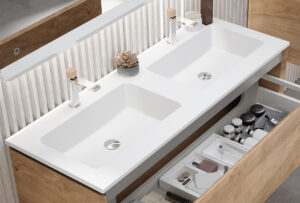 White double basin worktop with open oak vanity drawer revealing organised toiletries