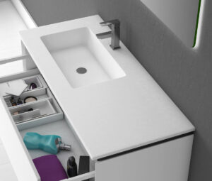 Left-hand inset white basin on white vanity with open storage drawer below