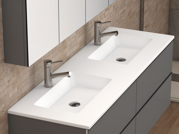 White double inset washbasin on grey wall-hung vanity unit with chrome taps