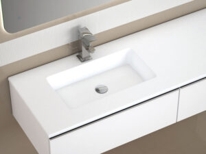 Close-up of a white inset washbasin with chrome mixer tap on a wall-hung vanity