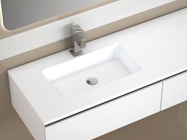 Close-up of a white inset washbasin with chrome mixer tap on a wall-hung vanity