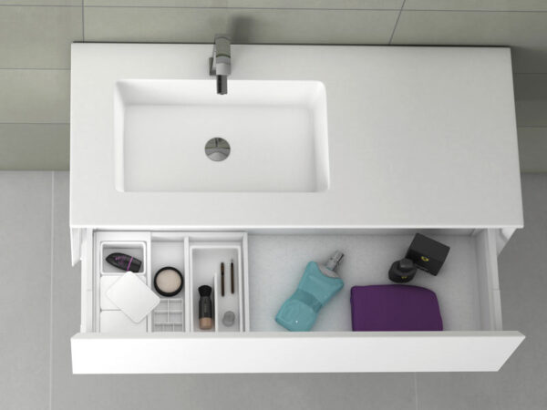 Top-down view of single inset washbasin with open drawer containing toiletries