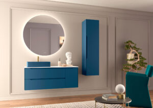 Deep blue wall hung vanity unit with matching tall cabinet and round mirror