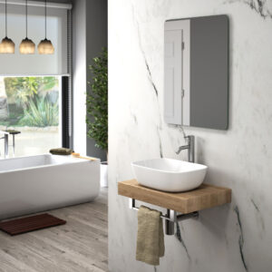 White oval countertop basin on small oak floating shelf beside freestanding bath and marble wall tiles