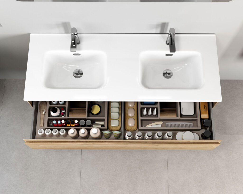 Overhead view of double basin vanity with two open drawers filled with organised toiletries