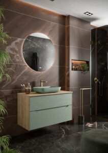 Sage green ribbed two-drawer vanity with oak top and green vessel basin against dark marble tiles