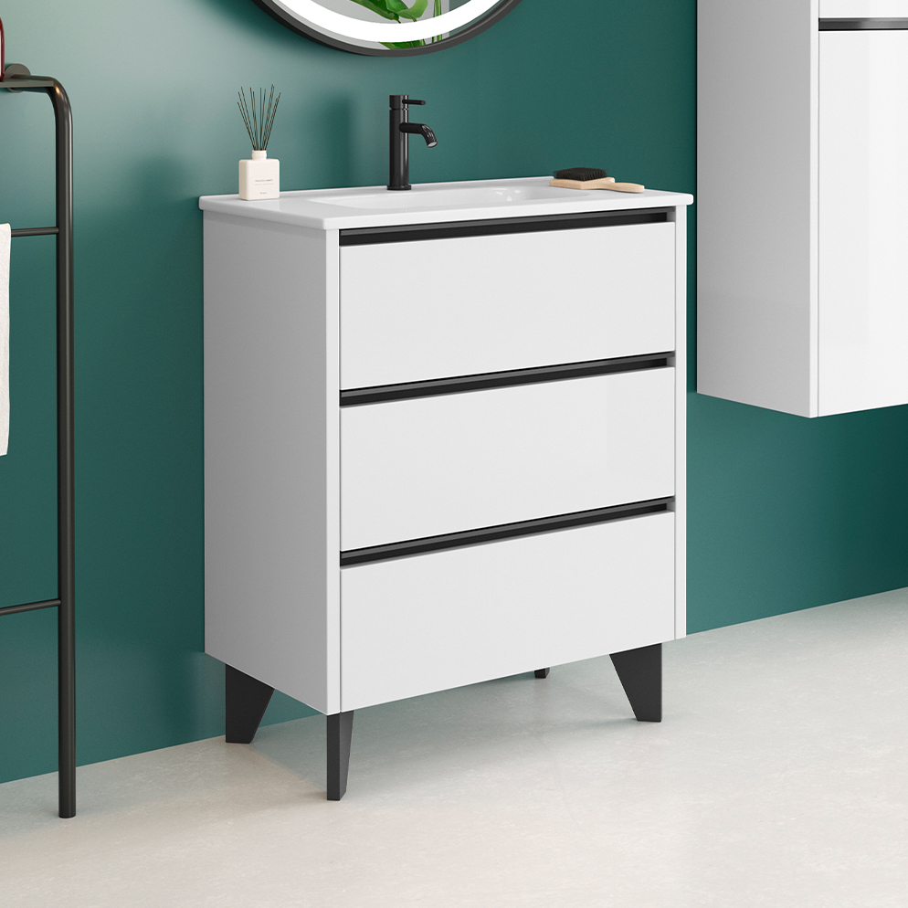 White freestanding three-drawer vanity unit with matte black handles and white basin