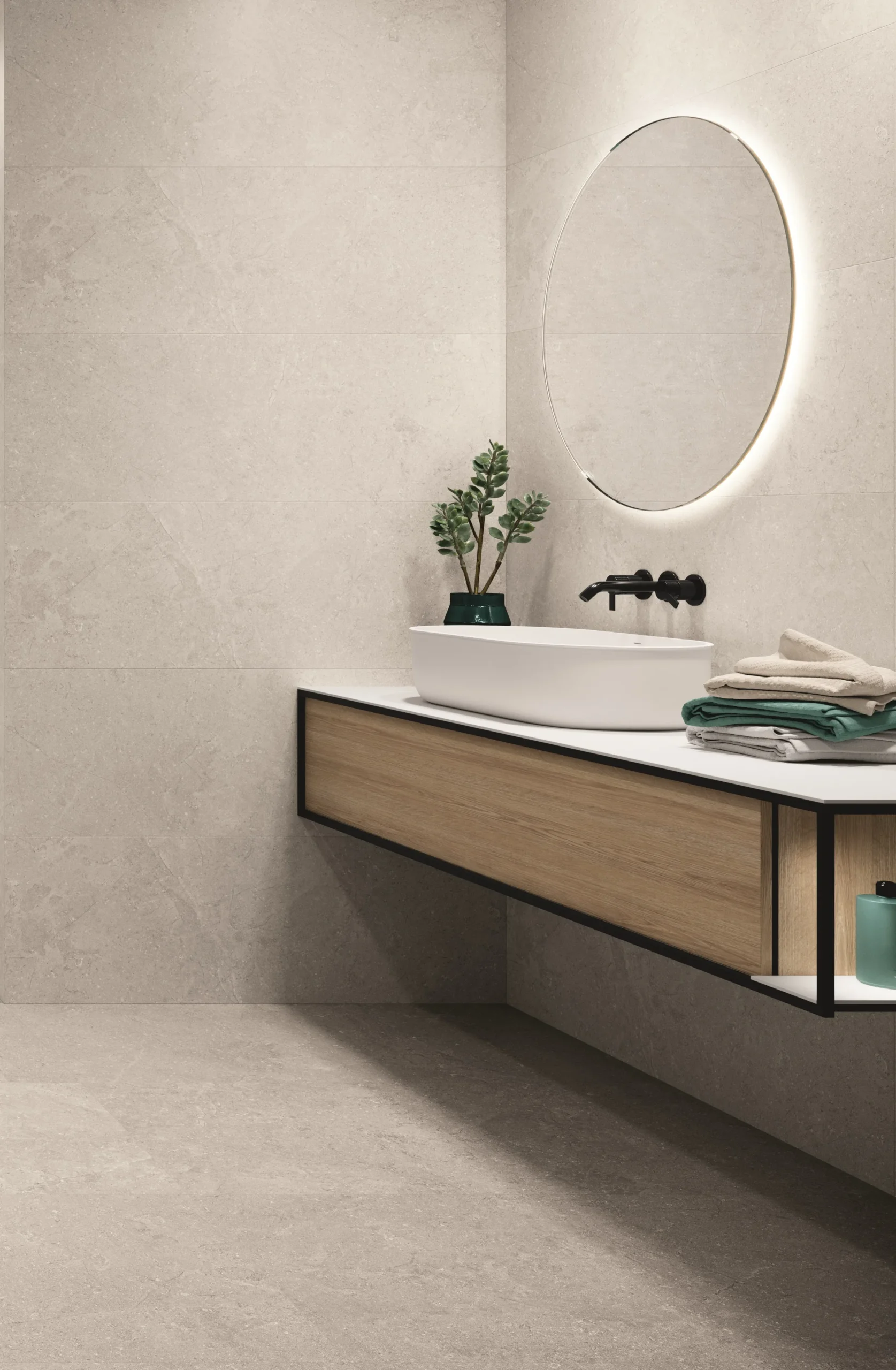 Matt ivory stone-effect ceramic tiles lining a contemporary bathroom with floating vanity