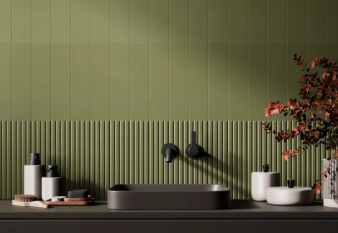 Olive green ribbed and plain wall tiles in a modern bathroom with black basin